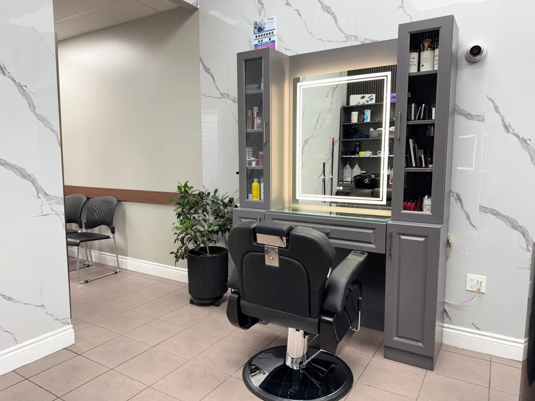 A styling station with a mirror, chair and flowers at 7 Heaven