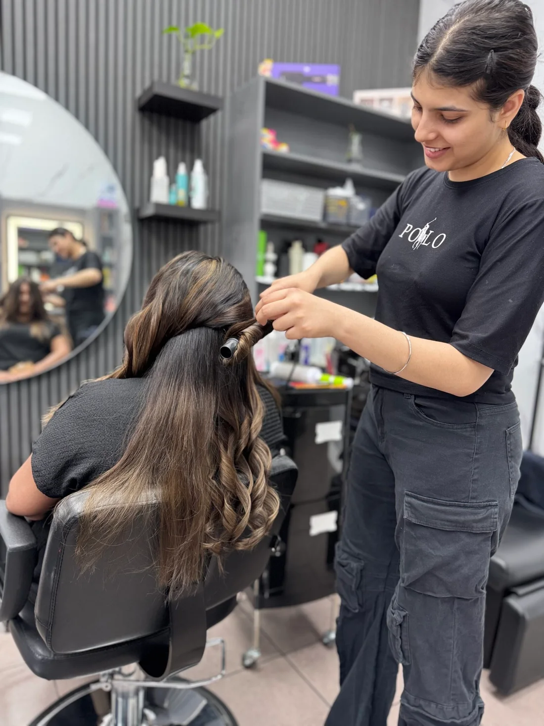 Khushi styling a client’s hair