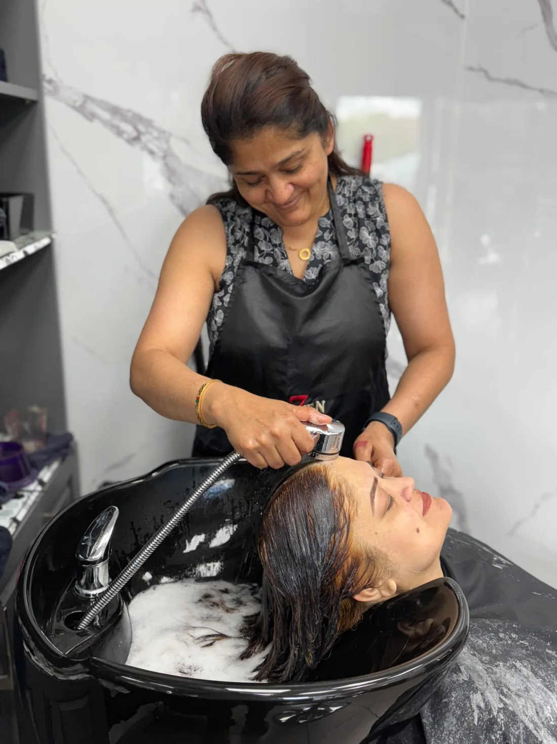 Neeru providing hair care at the salon